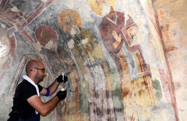 Wall paintings in St. Nicholas Museum being touched up